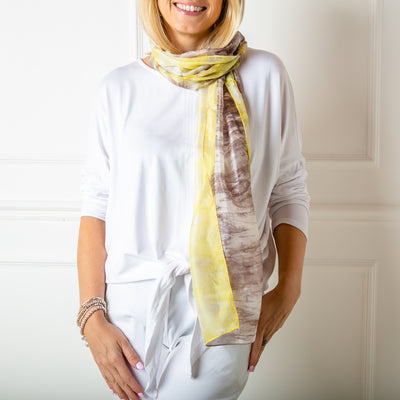 The grey and yellow tie dye print scarf made from 100% luxury silk. It makes the perfect gift for someone special.