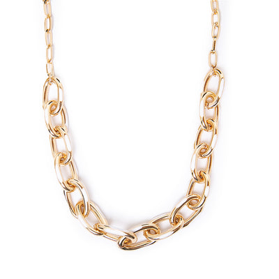 The Enya necklace in gold and white with a chunky metal chain and a metal clasp fastening