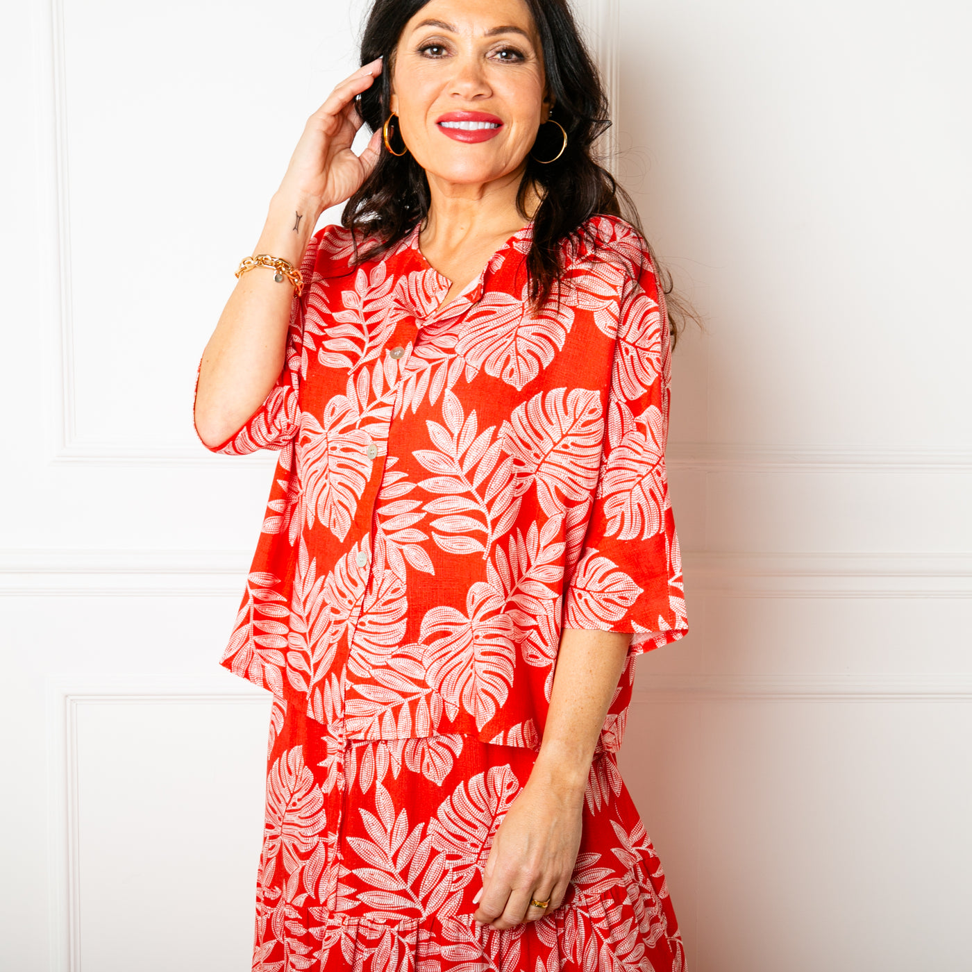 The red Linen Leaf Button Down Top featuring a beautiful tropical pattern full of leaves