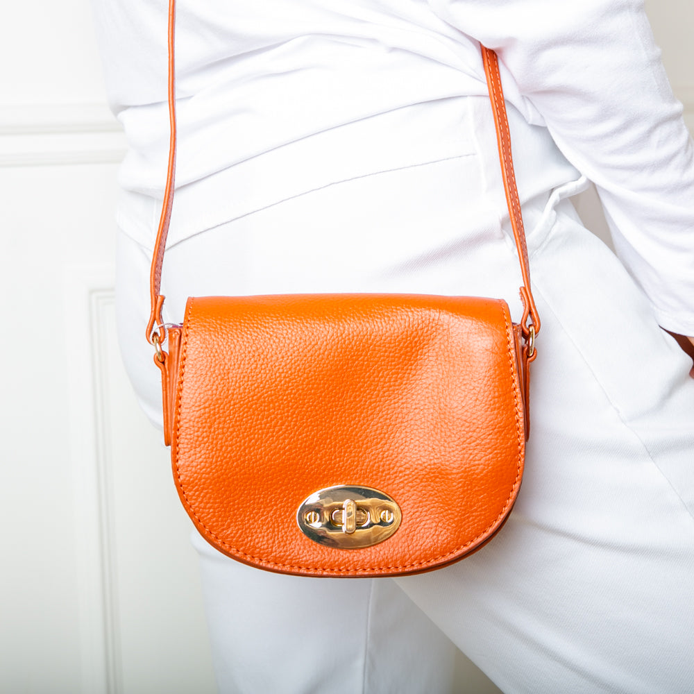 The Paris Leather Handbag in mandarin orange with a long, leather adjustable strap