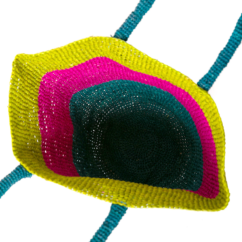 The Raffia Bucket Bag with blue green and pink crocheted stripes and a blue crocheted handle