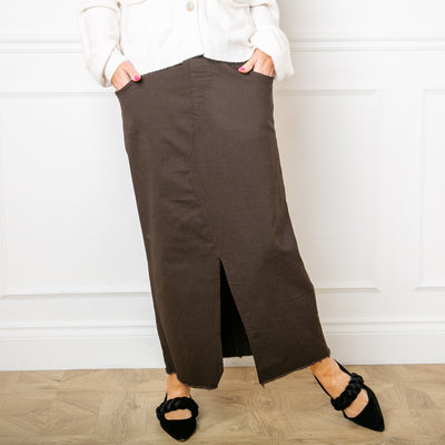 The chocolate brown Raw Hem Long Midi Skirt for women with side pockets on the front and larger pockets on the back