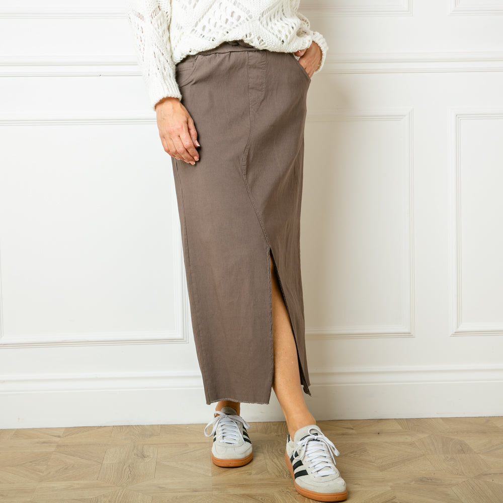 The taupe brown Raw Hem Long Midi Skirt for women with side pockets on the front and larger pockets on the back