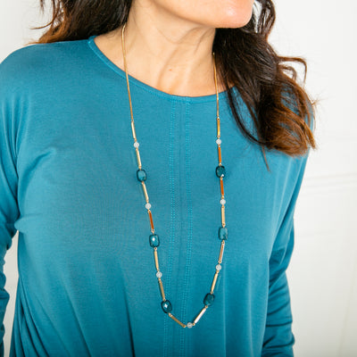 The Rhea Necklace in gold with a long fine chain that can be extended to desired length 