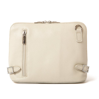Cream Italian leather Sloane Handbag, with a adjustable leather strap, three side zip, buckle detail and the outside pocket. Shown from the front.