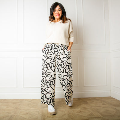 The Twist Trousers in white with an elasticated waist and pockets on either side