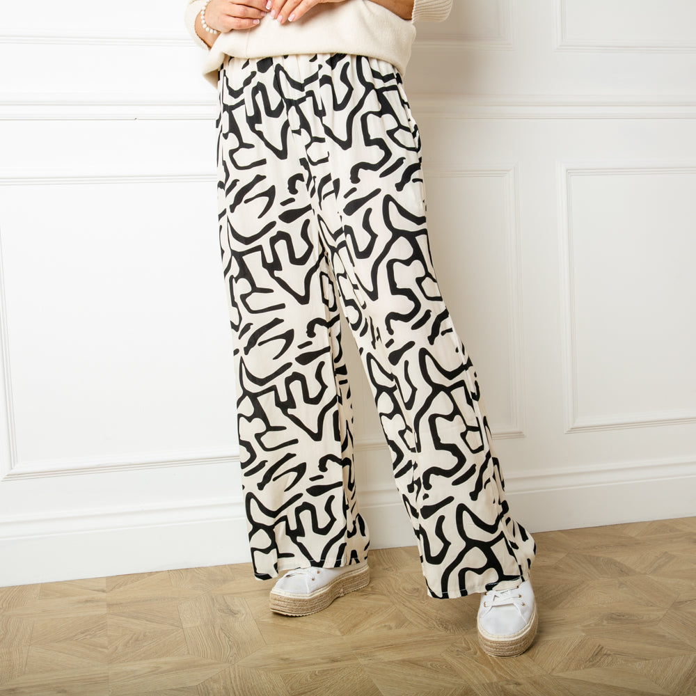 The Twist Trousers in white with a wide leg silhouette perfect for a relaxed fit