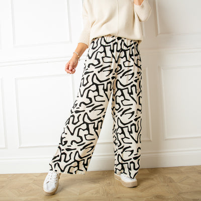The Twist Trousers in white featuring a fun white abstract squiggle pattern 