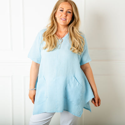The baby blue Two Pocket Linen Top with a statement flared hemline