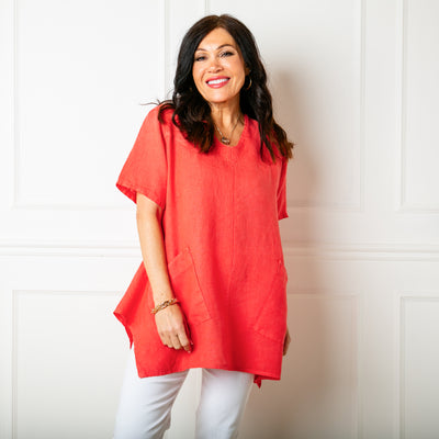 The coral red orange Two Pocket Linen Top with short sleeves and a rounded v neckline 