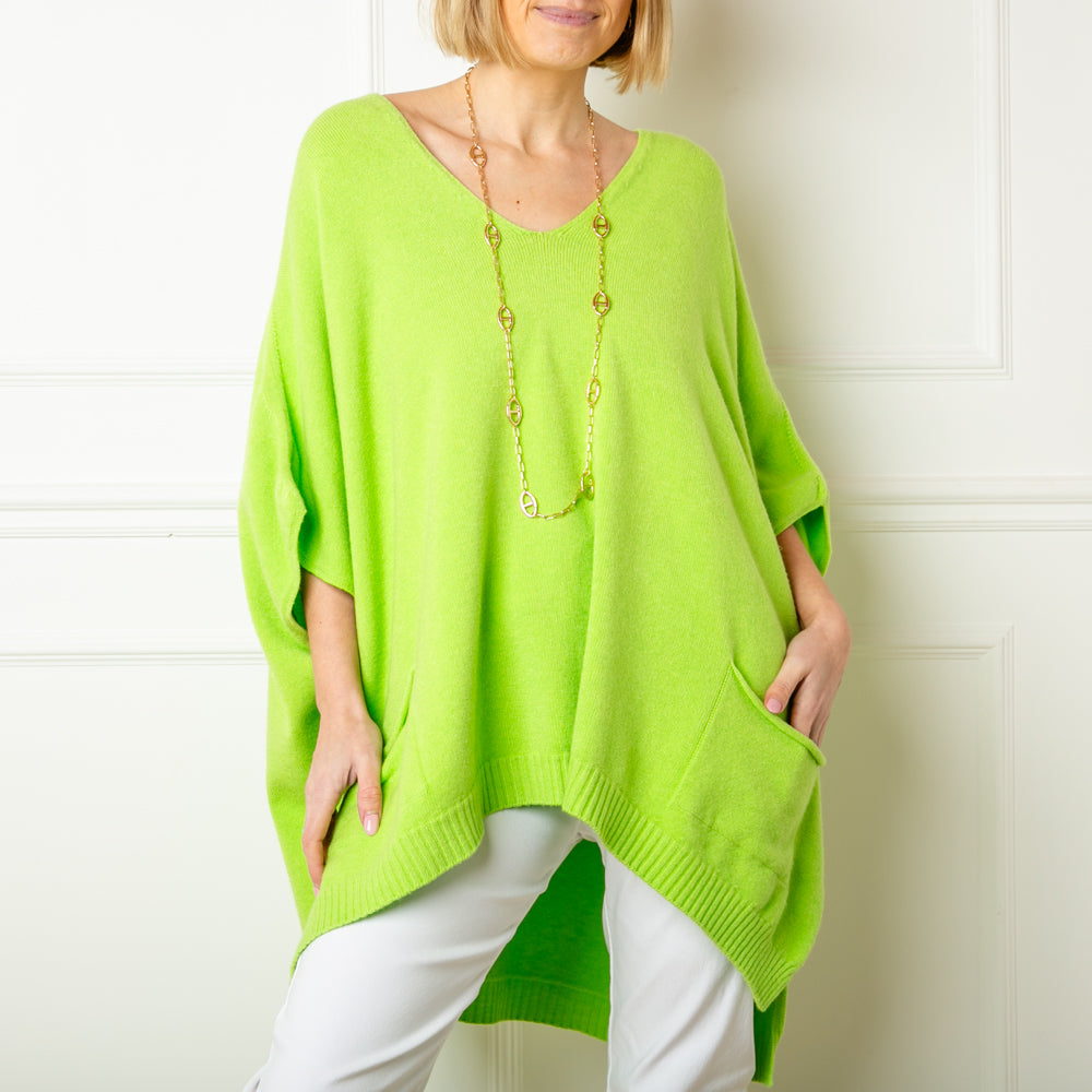 The lime green V neck pocket poncho jumper with 3/4 length sleeves that fall to the elbow and pockets on either side of the front