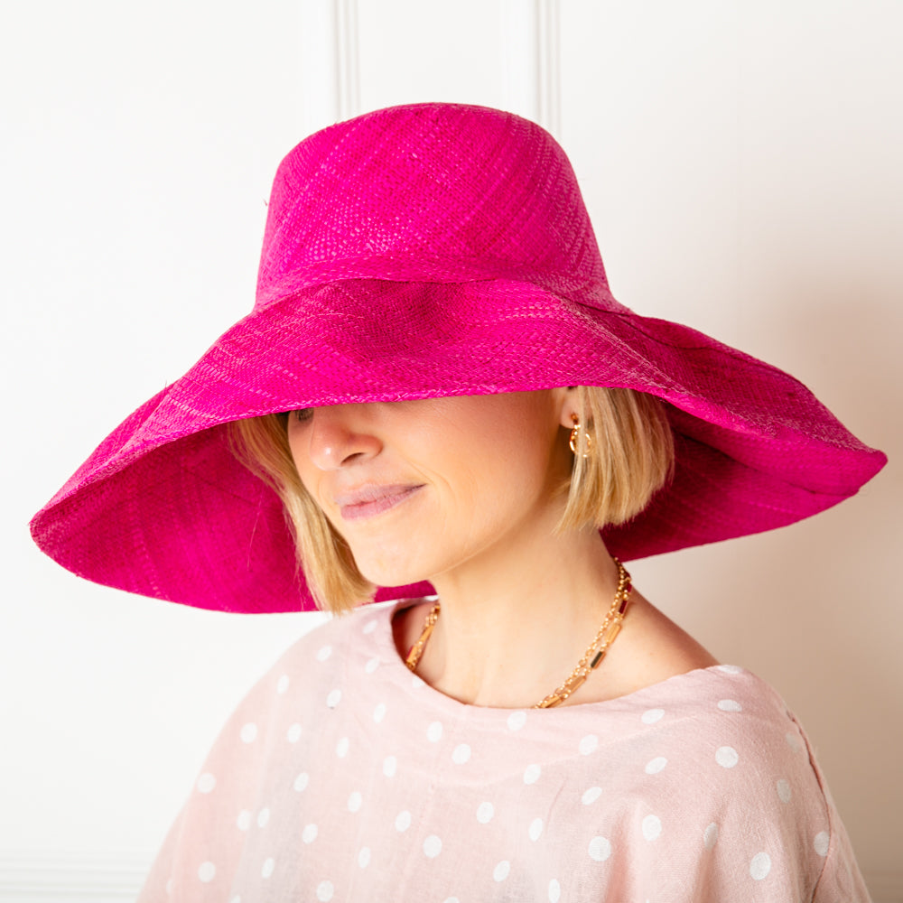 The bright pink Versailles Sun Hat Which can be styled in lots of different ways with the brim folded up or down