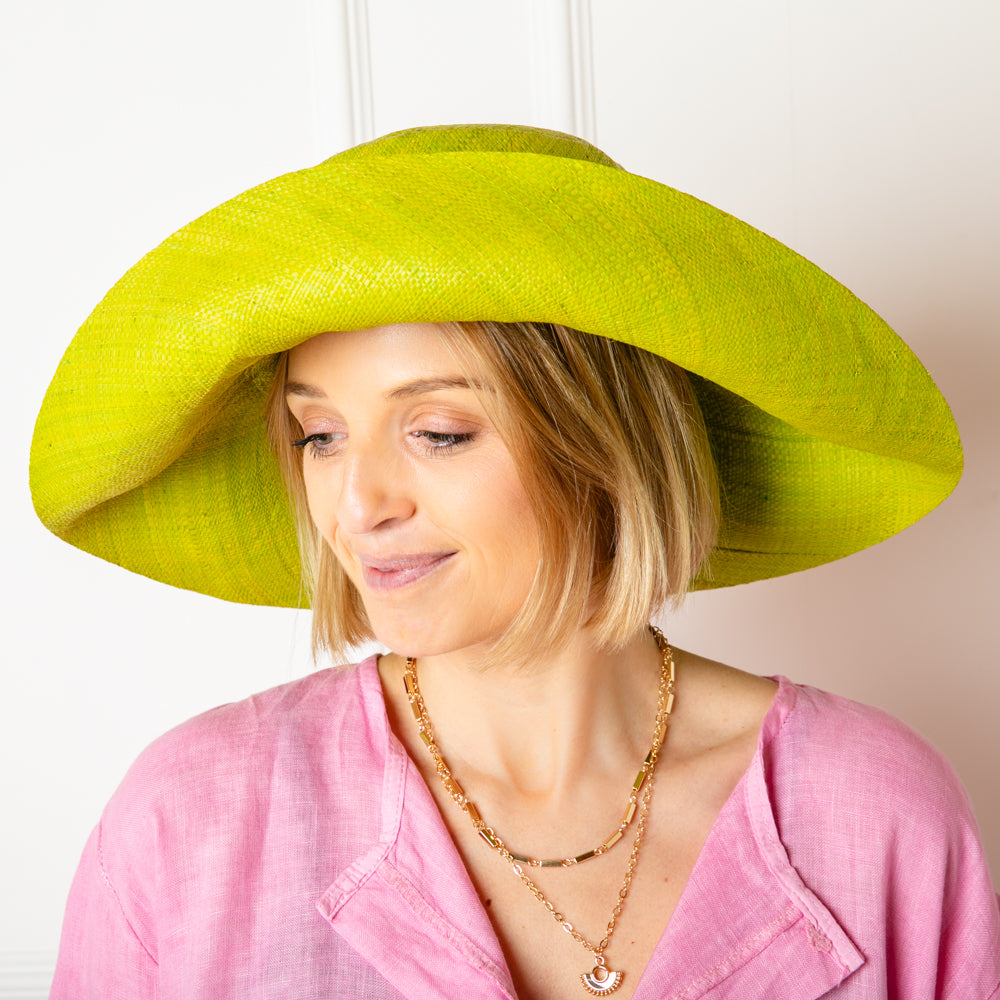The lime green Versailles Sun Hat Which can be styled in lots of different ways with the brim folded up or down