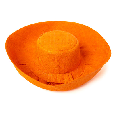 The orange Versailles Sun Hat with a wide brim and a bow detail around the circumference 