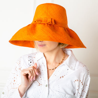 The Versailles Sun Hat in orange handmade in Madagascar from sustainable raffia