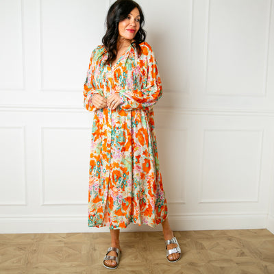 The orange Wild Garden Maxi Dress with buttons down the front and elasticated shirring over the bust for added stretch