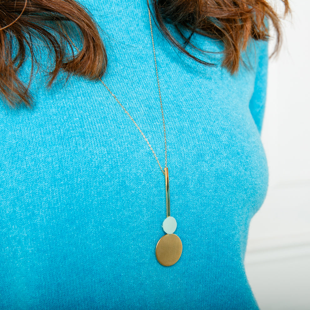 The Winona Necklace in blue with a long chain that can be adjusted to the desired length 