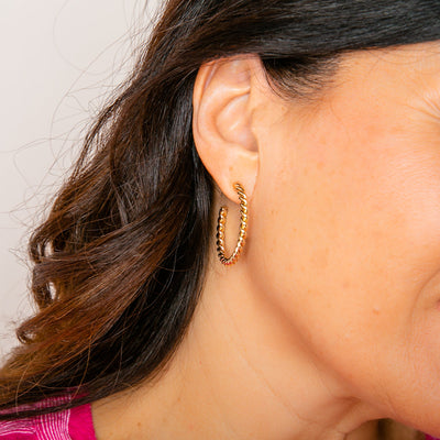 Amy hoop earrings, twisted hoop in gold, shown on model. Lightweight hoop