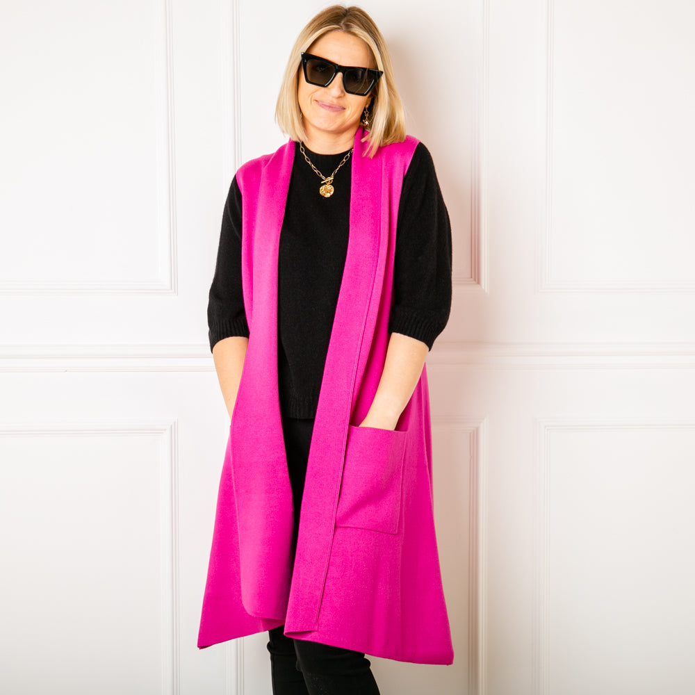 Sleeveless Cardigan in Fuchsia, pockets either side, mid length, women's knitwear, super soft, super cosy, front profile. Open front cardigan