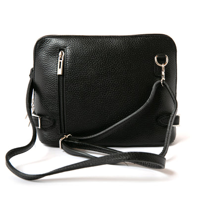 Extended adjustable strap shot of Black Italian leather Sloane Handbag, three side zip fastening, buckle detail and the outside pocket. Shown from the front.