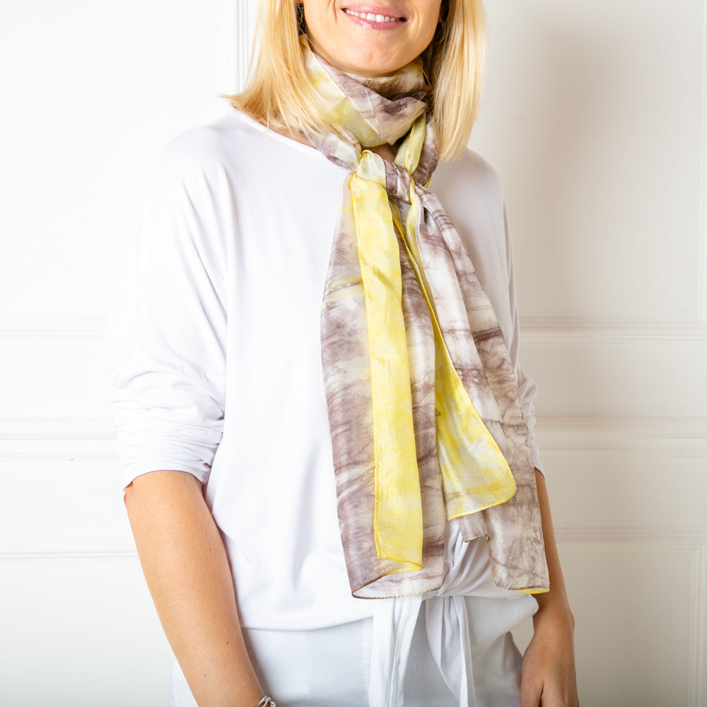 The grey and yellow tie dye print 100% silk demi scarf in a slimmer width to our regular silk scarf collection 