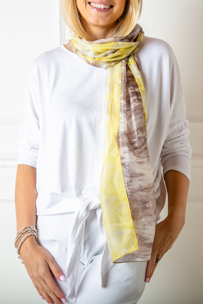 The grey and yellow tie dye print scarf made from 100% luxury silk. It makes the perfect gift for someone special.