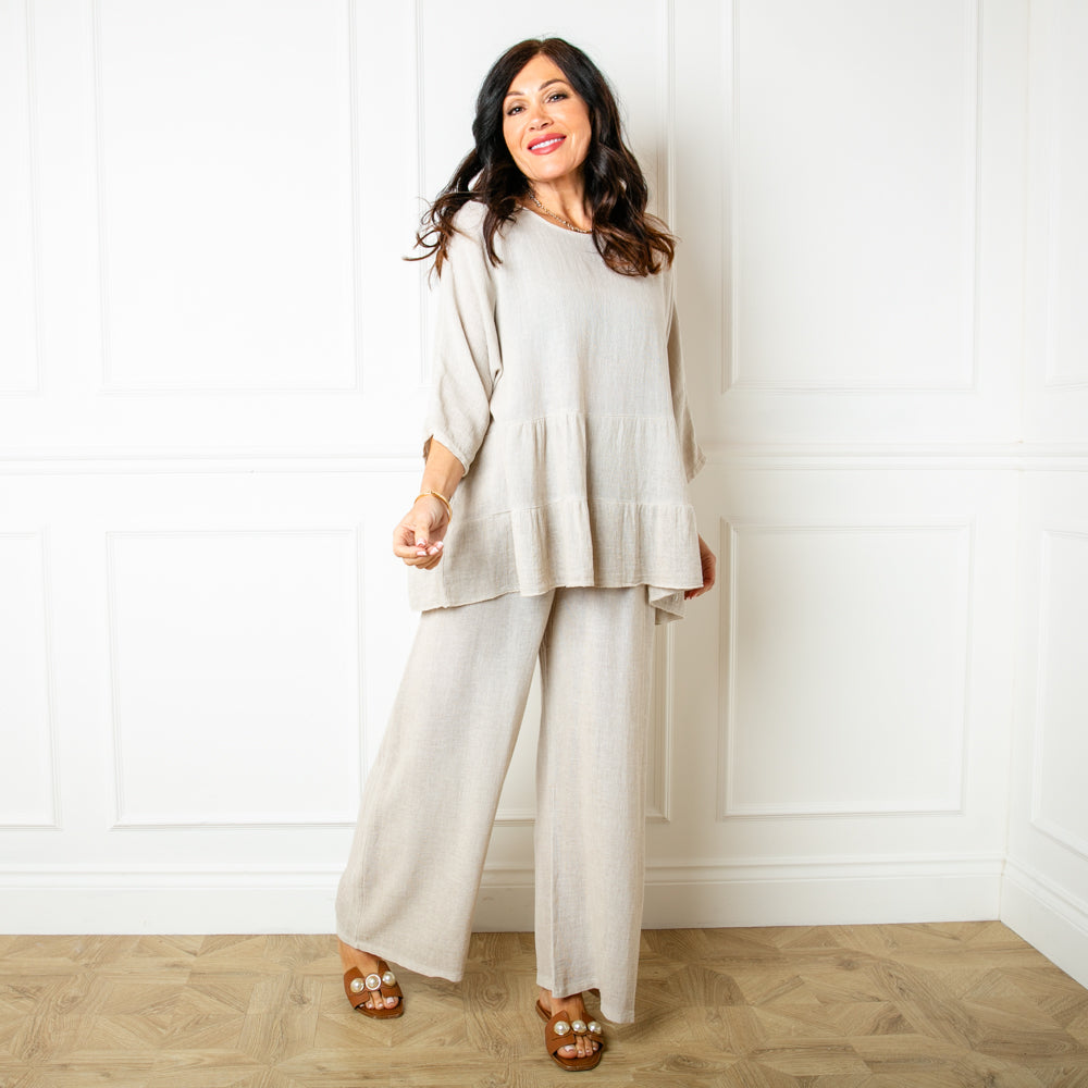 The Linen Blend Tiered Top in stone cream with 3/4 length sleeves and a round neckline