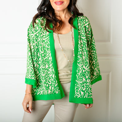 The Lightweight Graphic Kimono in green in a fun, colourful print with an open front