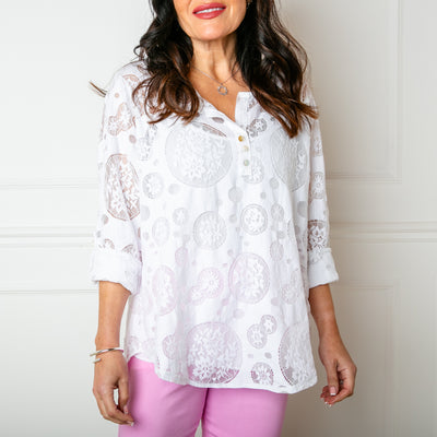 The Broderie Mesh Blouse in white with buttons down the front to the bust and a vest top underneath