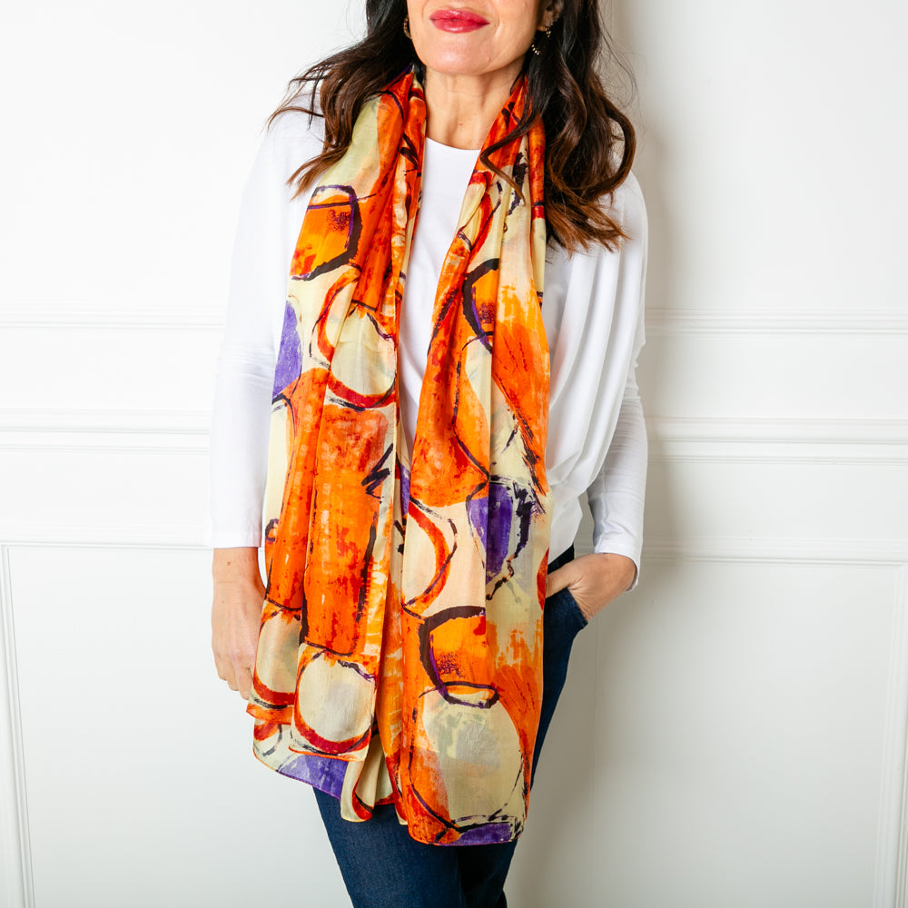 The Orange Circles Silk Scarf which can be worn in lots of different ways