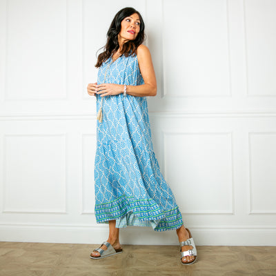 The blue All Over Print Maxi Dress with a v neckline and a tassel tie detail around the neck