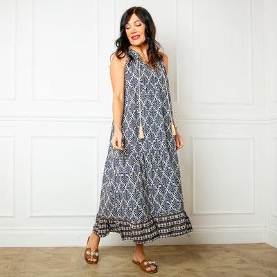 The navy blue All Over Print Maxi Dress with a v neckline and a tassel tie detail around the neck