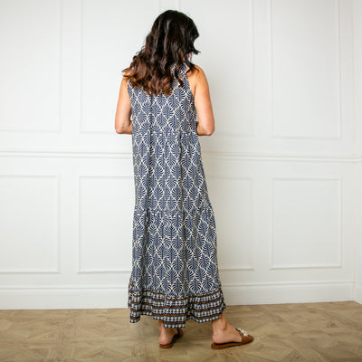 The navy blue All Over Print Maxi Dress featuring a vibrant leaf style print perfect for summer