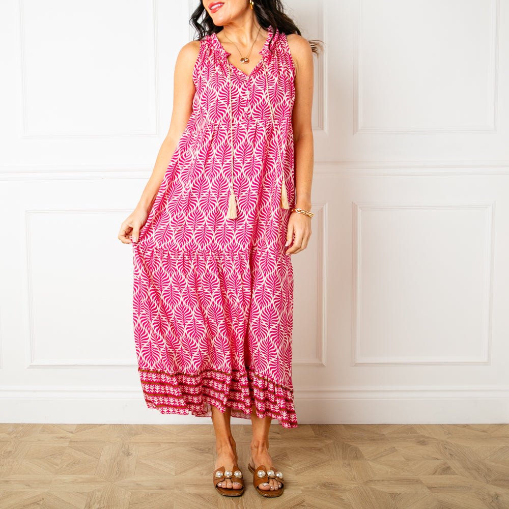 The pink All Over Print Maxi Dress with a v neckline and a tassel tie detail around the neck