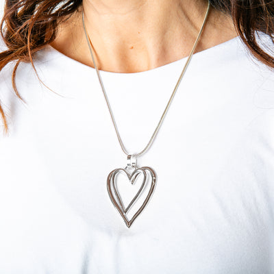 The silver Amara Necklace with layered heart pendants 