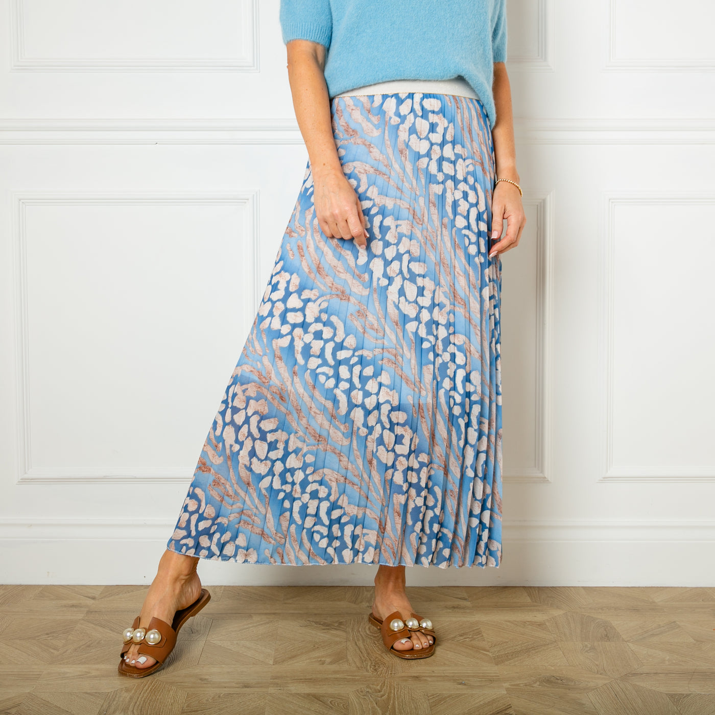 The blue Animal Print Pleated Skirt featuring a gorgeous leopard print pattern