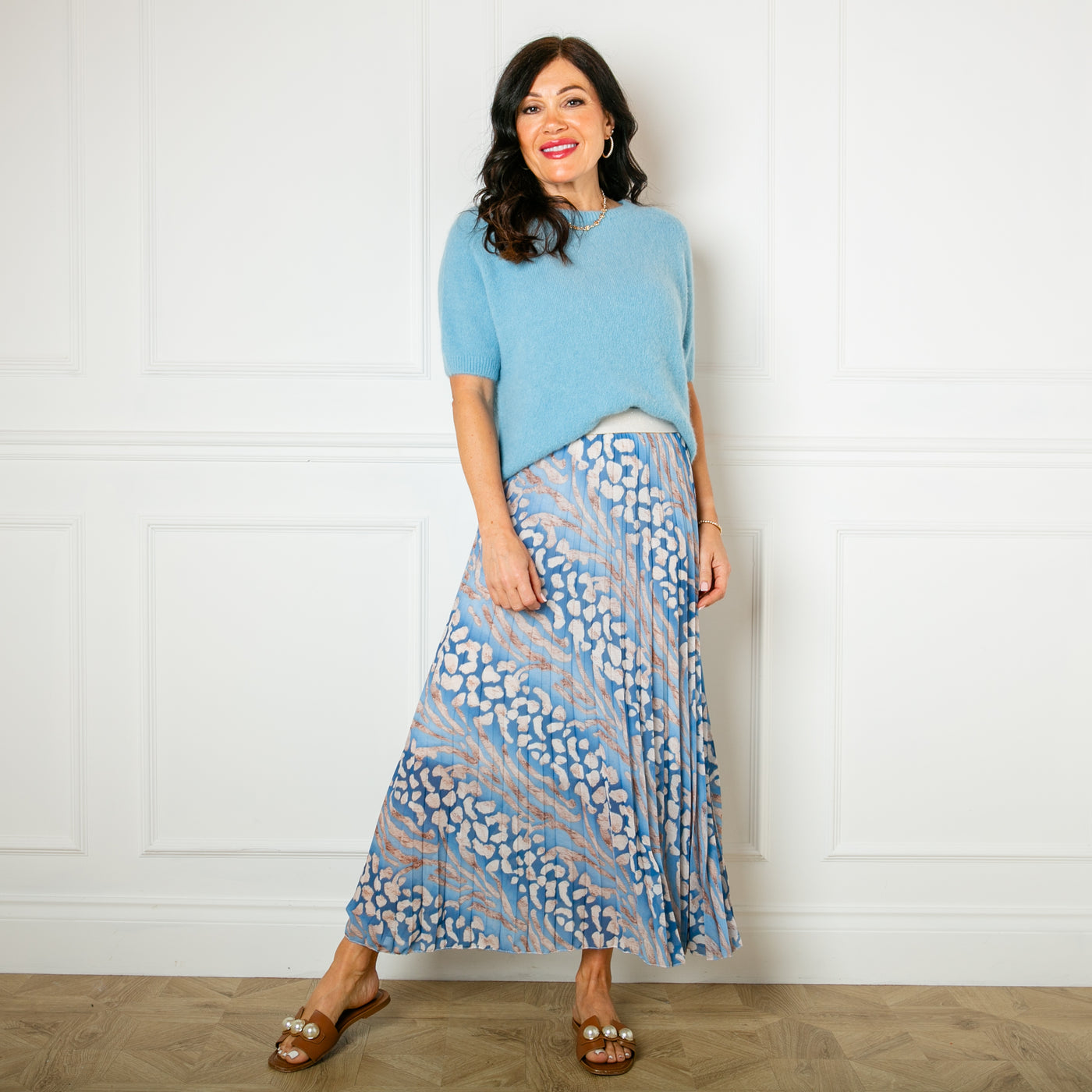 The blue Animal Print Pleated Skirt with a plain white underskirt underneath for added modesty