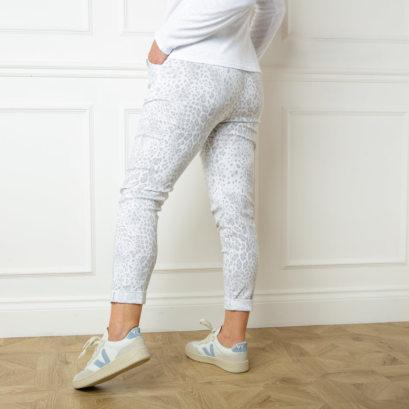 The white Animal Print Stretch Trousers with a drawstring elasticated waistband and pockets on either side