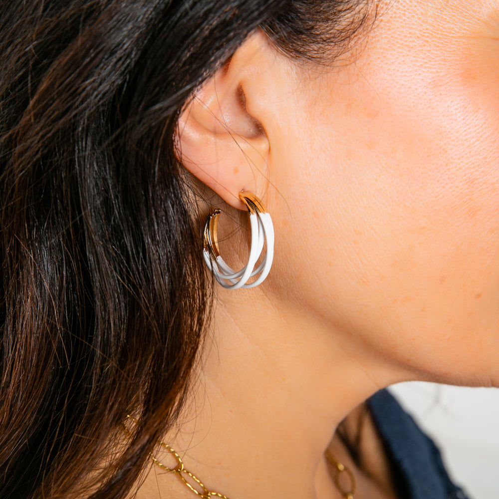 The Aria Earrings in white and gold. A chunky layered hoop perfect for adding a pop of colour to an outfit.