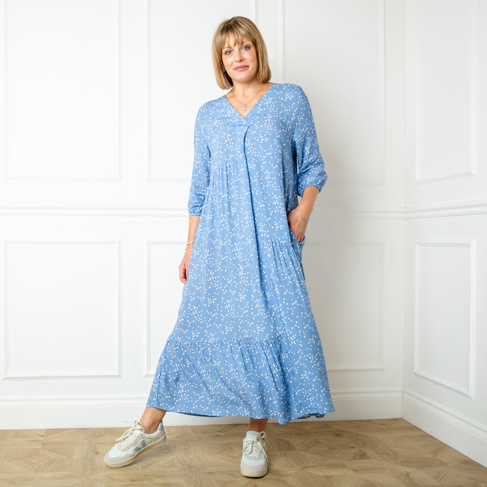 The Asymmetric 3/4 Sleeve Tea Dress in denim blue with a neckline and sleeves that fall just below the elbow with an elasticated cuff