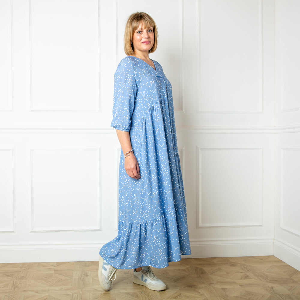 The denim blue Asymmetric 3/4 Sleeve Tea Dress in a fun spotty polka dot print with pockets on either side of the torso