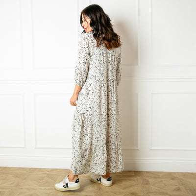 The ivory cream Asymmetric 3/4 Sleeve Tea Dress in a fun spotty polka dot print with pockets on either side of the torso