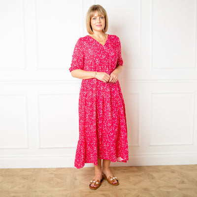 The raspberry pink Asymmetric 3/4 Sleeve Tea Dress in a fun spotty polka dot print with pockets on either side of the torso