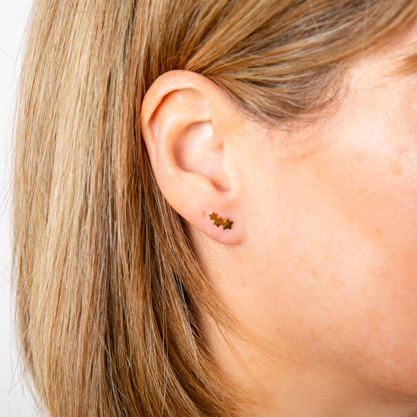 Ava Earrings in gold consisting of three small stars joined together