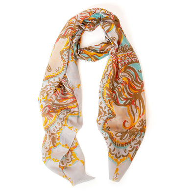 The taupe brown Bali Scarf with a white background and hints of orange and yellow