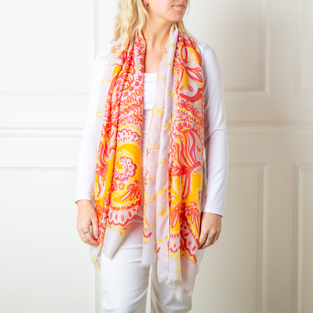 The orange Bali Scarf featuring a beautiful intricate paisley pattern print including floral designs