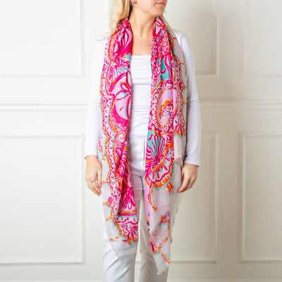 The fuchsia pink Bali Scarf featuring a beautiful intricate paisley pattern print including floral designs