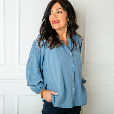 The Balloon Sleeve Shirt in denim blue with long sleeves featuring beautiful broderie embroidery detailing