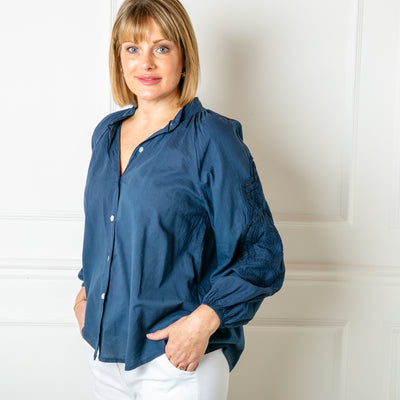 The Balloon Sleeve Shirt in navy blue with long sleeves featuring beautiful broderie embroidery detailing