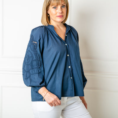 The nay blue Balloon Sleeve Shirt with a collarless V neckline and buttons down the front